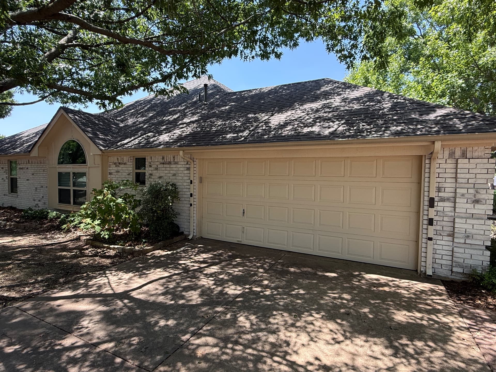 Cream garage door and trim before repaint