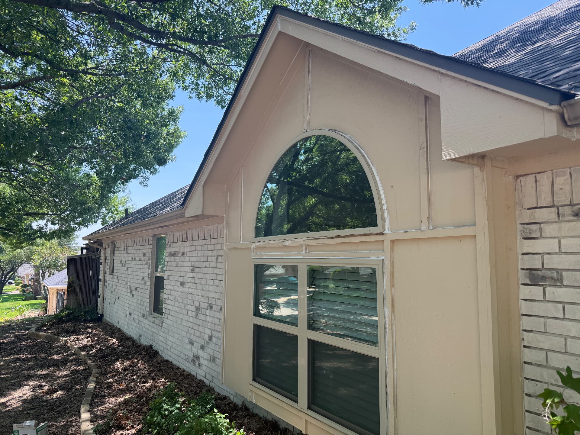 Cream gable siding and window trim before repaint