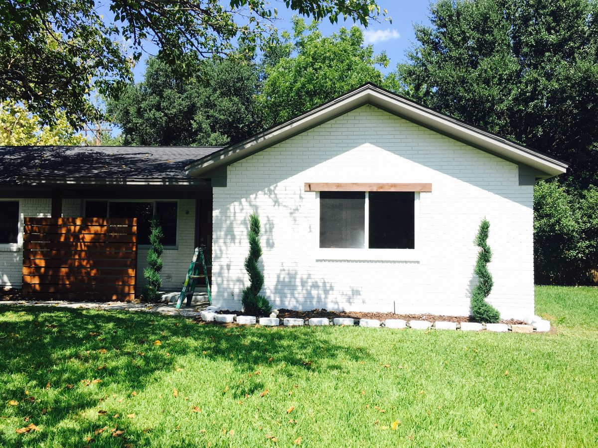 Brick home exterior painted white